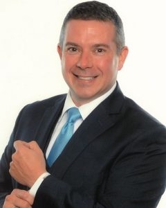 Image of a smiling man wearing business attire